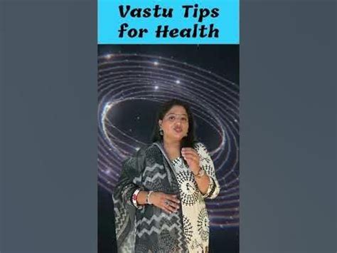 A Woman Standing In Front Of A Poster With The Words Vastu Tips For Health