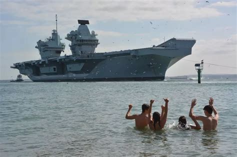 Sunbathers Wave Home Hms Prince Of Wales As Aircraft Carrier Returns To Portsmouth Hampshirelive